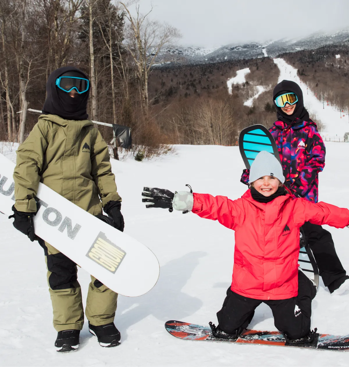 Happy children in front of ski trails